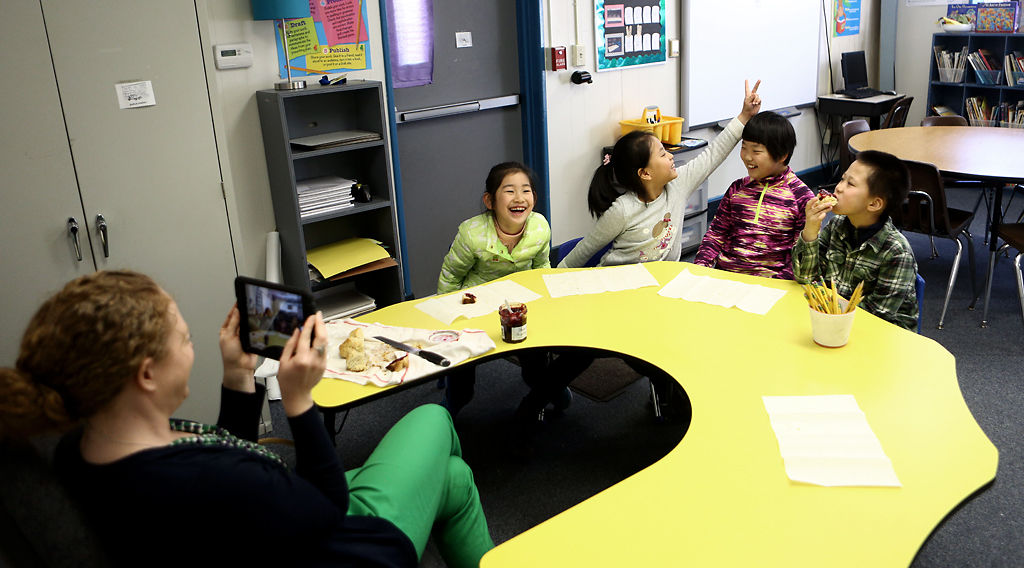 Katie Cook uses an iPad to take photos of her students
